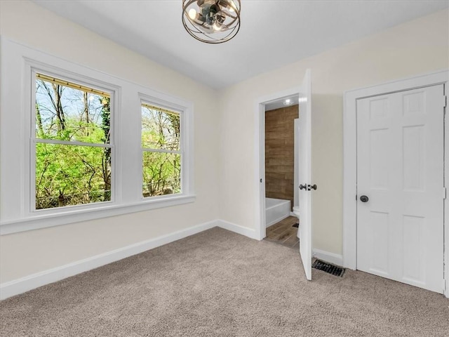 3928 E 58th St, Kansas City, MO 64132 - unfurnished bedroom with light carpet and baseboards
