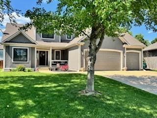 23968 Eagle Ct, Paola, KS 66071 - view of front facade with a front yard, driveway, and a garage