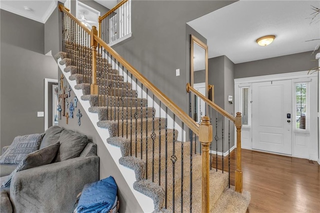 23968 Eagle Ct, Paola, KS 66071 - foyer with wood finished floors, stairway, and crown molding