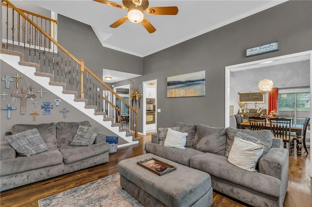 23968 Eagle Ct, Paola, KS 66071 - living room with ceiling fan, stairway, wood finished floors, a high ceiling, and crown molding