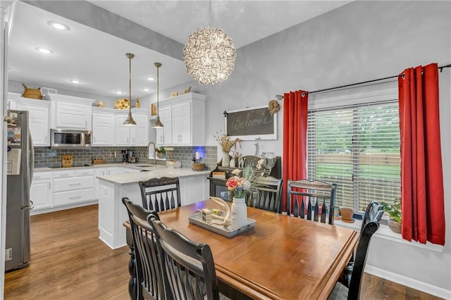 23968 Eagle Ct, Paola, KS 66071 - dining space featuring a chandelier and dark wood-style flooring