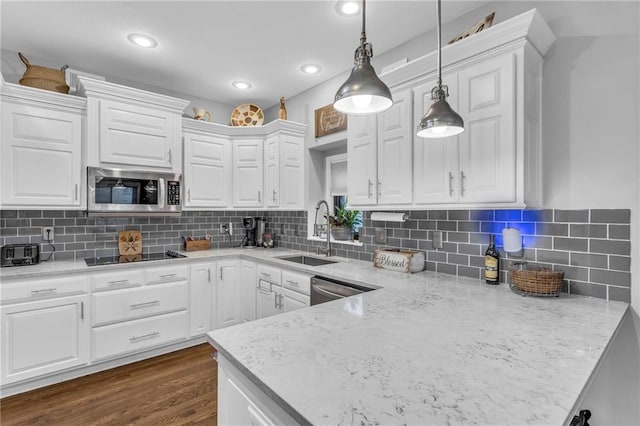 23968 Eagle Ct, Paola, KS 66071 - kitchen featuring stainless steel appliances, white cabinetry, decorative light fixtures, dark wood finished floors, and recessed lighting