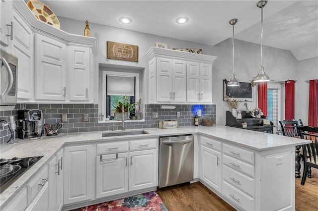 23968 Eagle Ct, Paola, KS 66071 - kitchen with appliances with stainless steel finishes, a peninsula, white cabinetry, tasteful backsplash, and recessed lighting