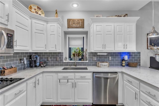 23968 Eagle Ct, Paola, KS 66071 - kitchen featuring appliances with stainless steel finishes, white cabinetry, and tasteful backsplash
