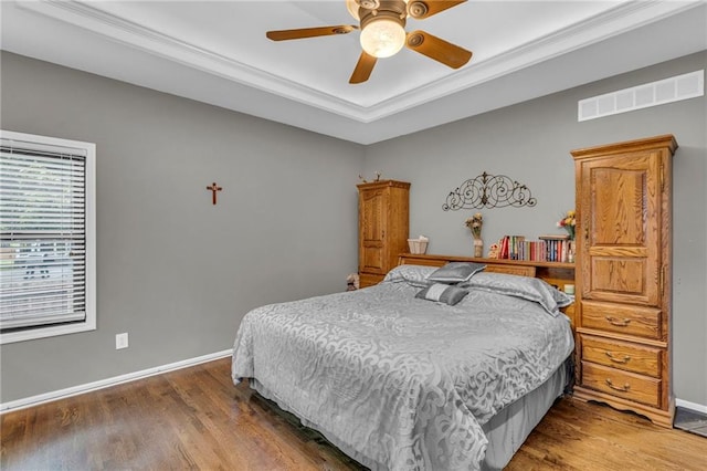 23968 Eagle Ct, Paola, KS 66071 - bedroom featuring wood finished floors, ornamental molding, a raised ceiling, and a ceiling fan