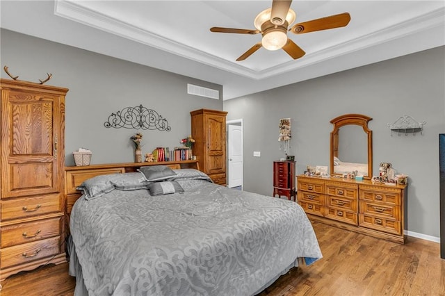 23968 Eagle Ct, Paola, KS 66071 - bedroom with a tray ceiling, wood finished floors, ornamental molding, and a ceiling fan