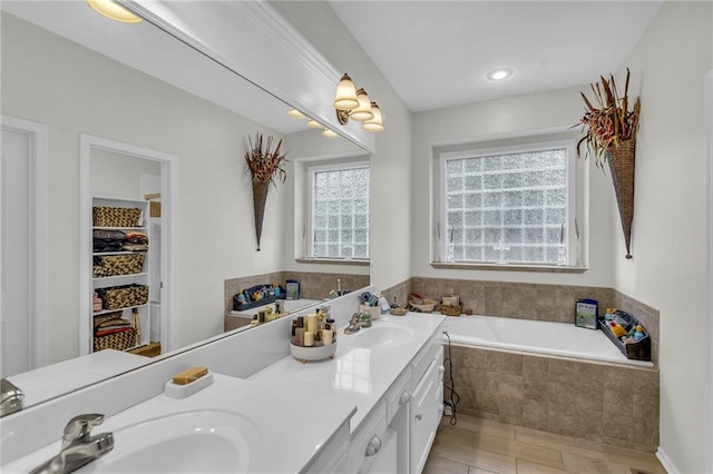 23968 Eagle Ct, Paola, KS 66071 - bathroom with a bath, double vanity, and a walk in closet