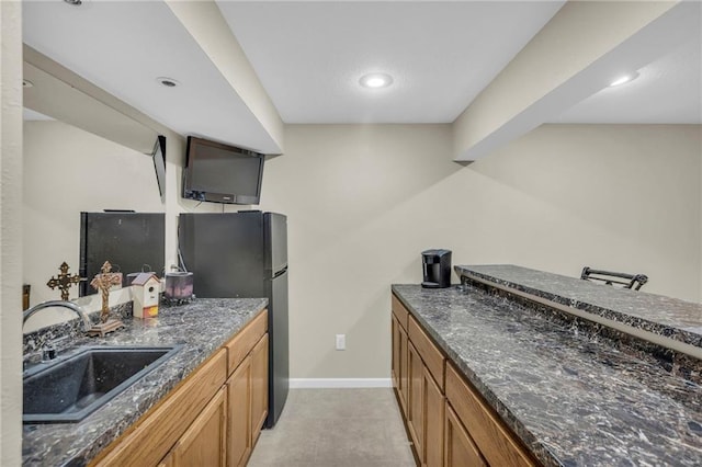 23968 Eagle Ct, Paola, KS 66071 - kitchen with brown cabinetry, light tile patterned floors, dark stone counters, and recessed lighting