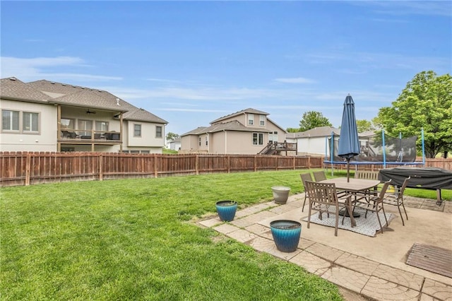23968 Eagle Ct, Paola, KS 66071 - fenced backyard featuring a trampoline and a patio area