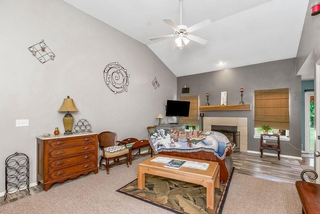 1229 Starbrooke Dr, Louisburg, KS 66053 - living area featuring lofted ceiling, a ceiling fan, and a tiled fireplace