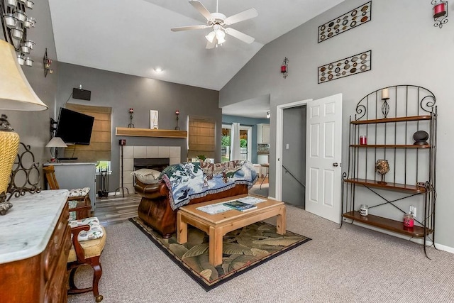 1229 Starbrooke Dr, Louisburg, KS 66053 - carpeted living room with lofted ceiling, ceiling fan, and a tile fireplace