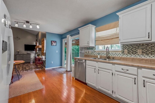 1229 Starbrooke Dr, Louisburg, KS 66053 - kitchen featuring dishwasher, backsplash, white cabinets, and light wood-style floors
