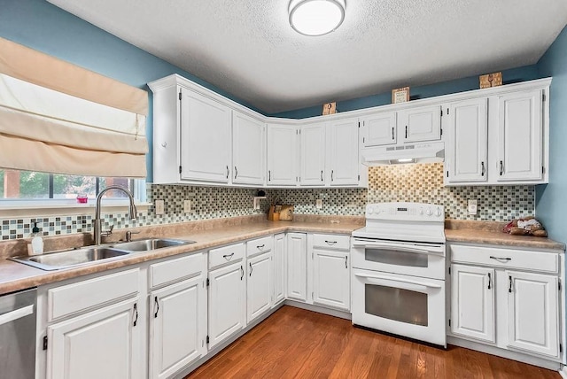 1229 Starbrooke Dr, Louisburg, KS 66053 - kitchen with range with two ovens, under cabinet range hood, stainless steel dishwasher, a textured ceiling, and white cabinets