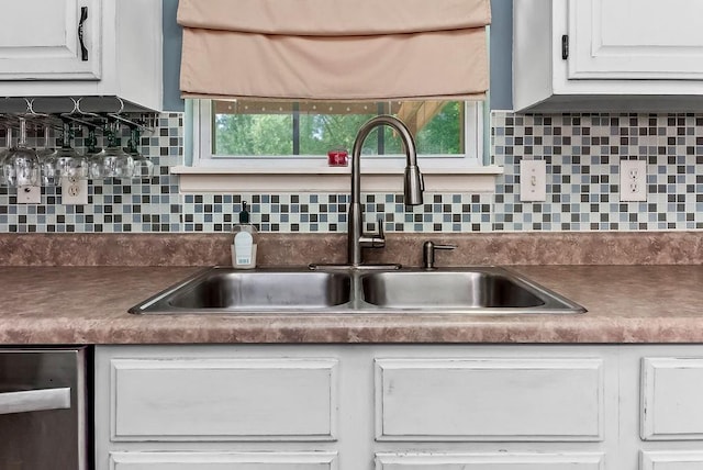 1229 Starbrooke Dr, Louisburg, KS 66053 - kitchen featuring dark countertops, dishwasher, white cabinetry, and tasteful backsplash