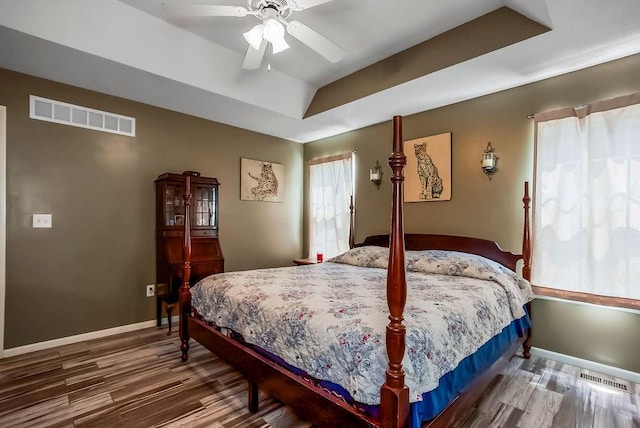 1229 Starbrooke Dr, Louisburg, KS 66053 - bedroom with wood finished floors, ceiling fan, and a raised ceiling