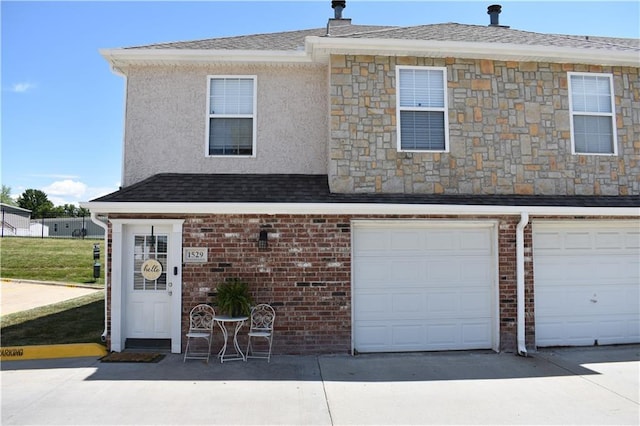 1529 E 120th St, Olathe, KS 66061 - view of front of house with a garage, brick siding, and driveway