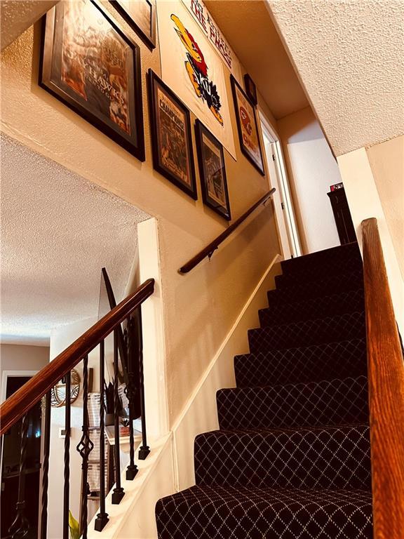 1529 E 120th St, Olathe, KS 66061 - stairs featuring a textured ceiling