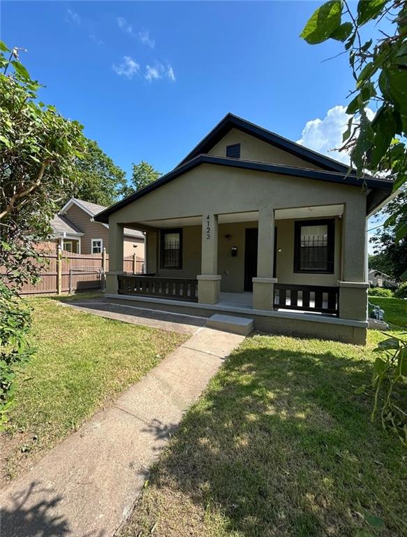 4123 E 6th St, Kansas City, MO 64124 - bungalow with a porch and stucco siding