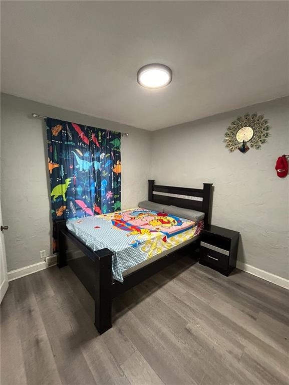 4123 E 6th St, Kansas City, MO 64124 - bedroom with wood finished floors and baseboards