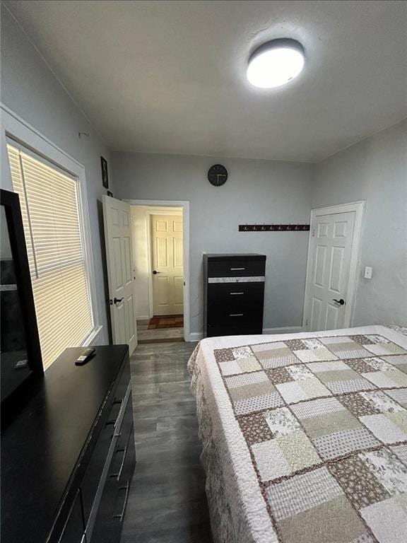 4123 E 6th St, Kansas City, MO 64124 - bedroom featuring dark wood finished floors and baseboards