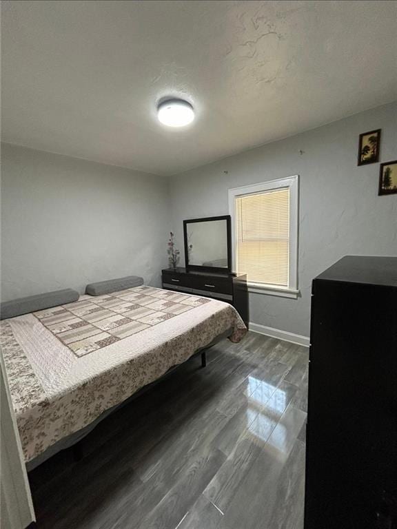 4123 E 6th St, Kansas City, MO 64124 - bedroom with baseboards and dark wood-style floors