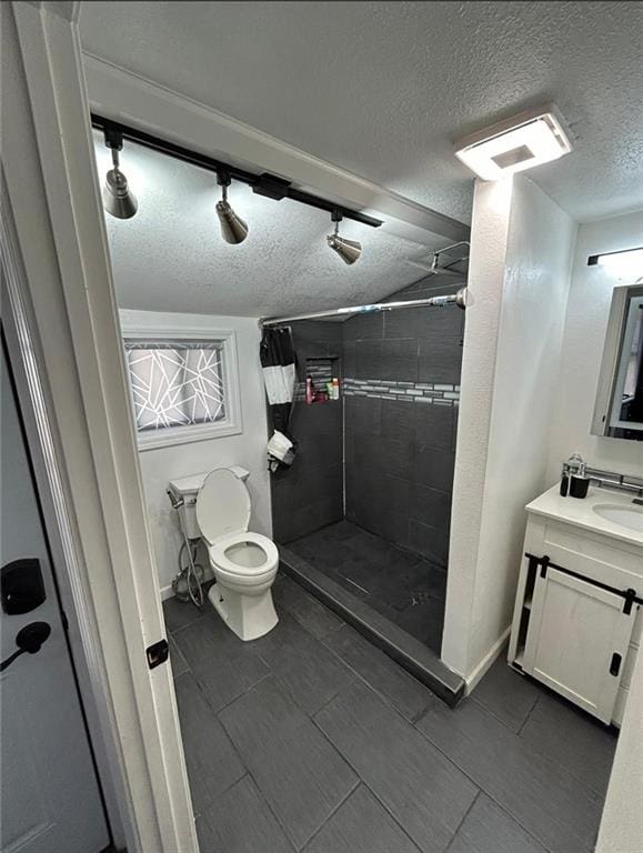 4123 E 6th St, Kansas City, MO 64124 - bathroom featuring vanity, a stall shower, a textured ceiling, and tile patterned flooring