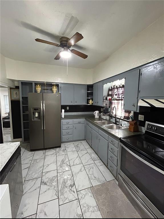 4123 E 6th St, Kansas City, MO 64124 - kitchen with stainless steel appliances, light marble finish floors, gray cabinetry, ceiling fan, and open shelves