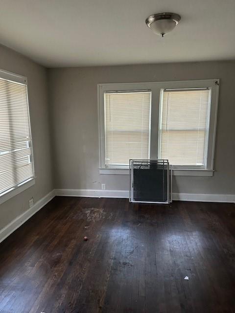 9600 E 16th St, Independence, MO 64052 - unfurnished room featuring wood finished floors and baseboards