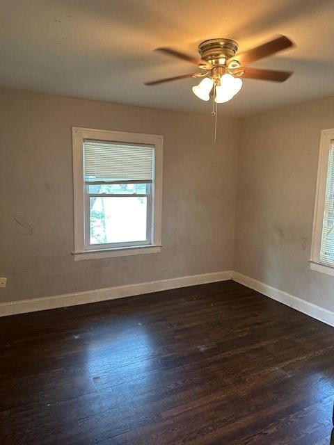 9600 E 16th St, Independence, MO 64052 - unfurnished room featuring dark wood-style floors and a ceiling fan