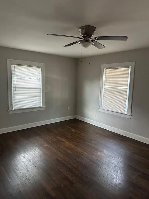 9600 E 16th St, Independence, MO 64052 - spare room with dark wood-style flooring and ceiling fan