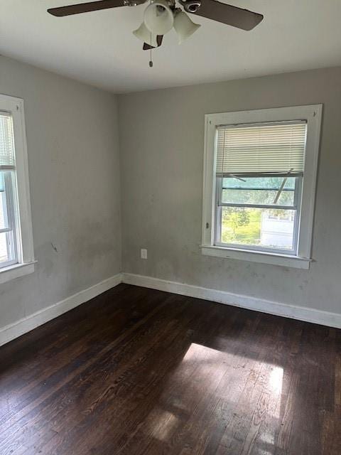 9600 E 16th St, Independence, MO 64052 - empty room with a ceiling fan, healthy amount of natural light, and dark wood-style floors