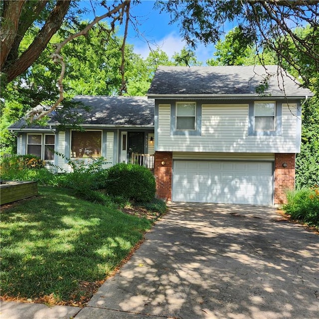 9318 Greenway Ln, Lenexa, KS 66215 - tri-level home featuring asphalt driveway, an attached garage, brick siding, and a front yard