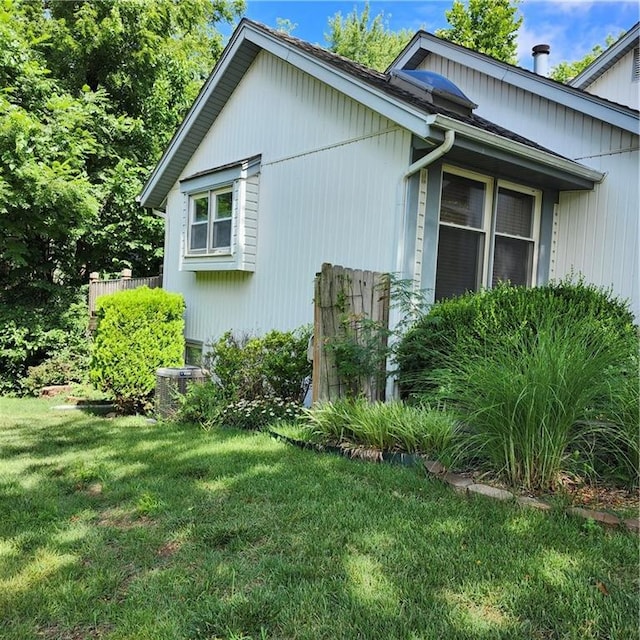 9318 Greenway Ln, Lenexa, KS 66215 - view of side of home featuring a yard and a cooling unit