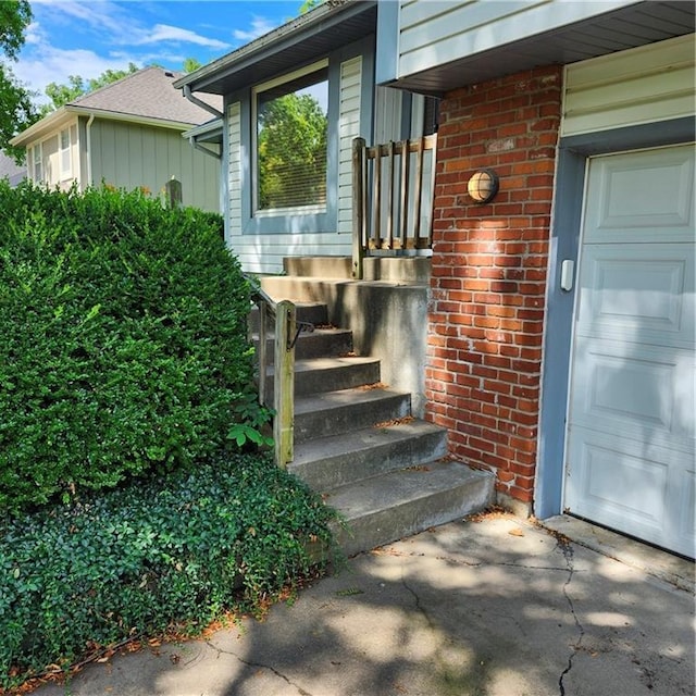 9318 Greenway Ln, Lenexa, KS 66215 - doorway to property featuring brick siding and a garage