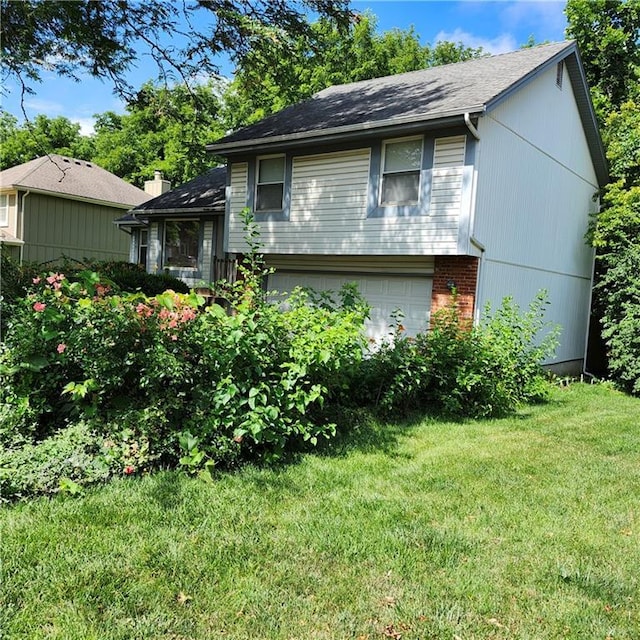 9318 Greenway Ln, Lenexa, KS 66215 - tri-level home featuring a front yard, brick siding, and an attached garage
