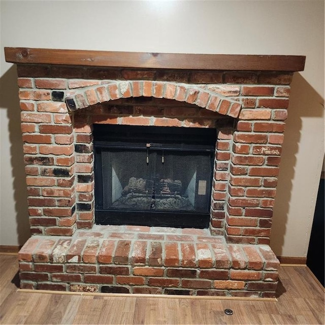9318 Greenway Ln, Lenexa, KS 66215 - detailed view of a fireplace and wood finished floors