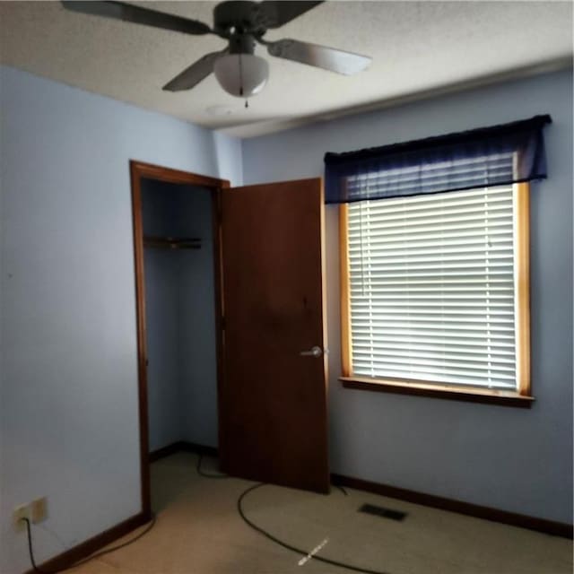 9318 Greenway Ln, Lenexa, KS 66215 - unfurnished bedroom featuring a closet, multiple windows, carpet floors, and ceiling fan