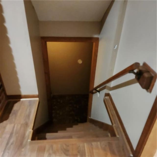 9318 Greenway Ln, Lenexa, KS 66215 - staircase featuring wood finished floors and baseboards