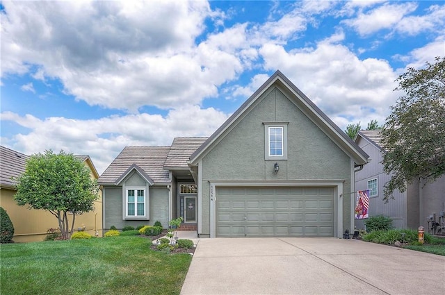 11514 W 143rd Ter, Olathe, KS 66062 - traditional home featuring stucco siding, concrete driveway, a front lawn, a tile roof, and an attached garage