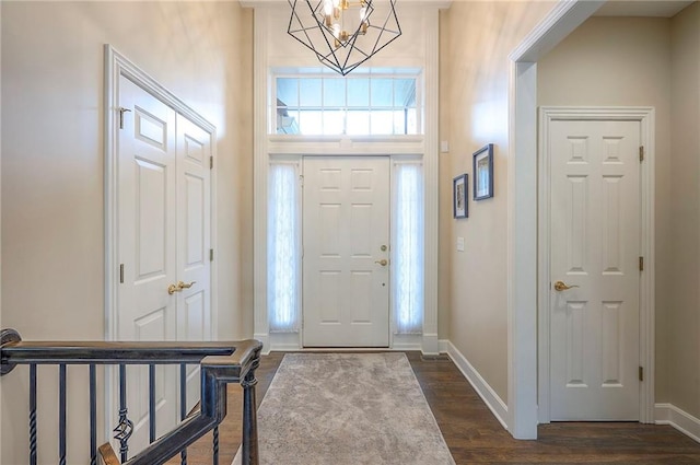 11514 W 143rd Ter, Olathe, KS 66062 - foyer entrance with dark wood-style floors and a chandelier