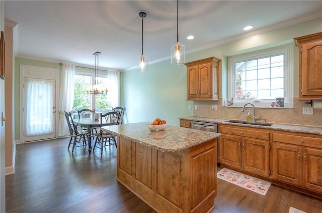 11514 W 143rd Ter, Olathe, KS 66062 - kitchen featuring a center island, crown molding, dark wood finished floors, brown cabinetry, and backsplash