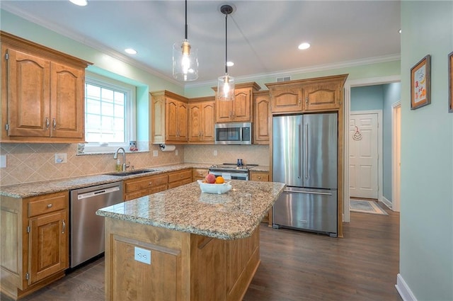 11514 W 143rd Ter, Olathe, KS 66062 - kitchen with appliances with stainless steel finishes, brown cabinetry, a kitchen island, dark wood finished floors, and ornamental molding