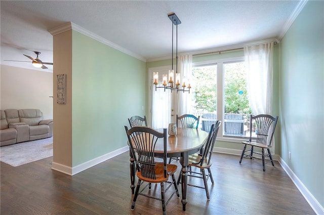 11514 W 143rd Ter, Olathe, KS 66062 - dining space featuring crown molding, a chandelier, dark wood-style floors, and a ceiling fan