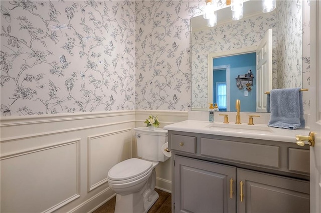 11514 W 143rd Ter, Olathe, KS 66062 - bathroom with wallpapered walls, wainscoting, vanity, and a decorative wall