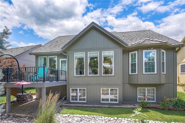 11514 W 143rd Ter, Olathe, KS 66062 - rear view of house featuring a wooden deck and a tile roof