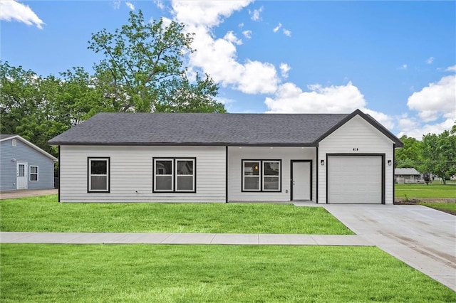 525 N Cedar St, Ottawa, KS 66067 - view of front of property featuring a garage, a front yard, driveway, and a shingled roof