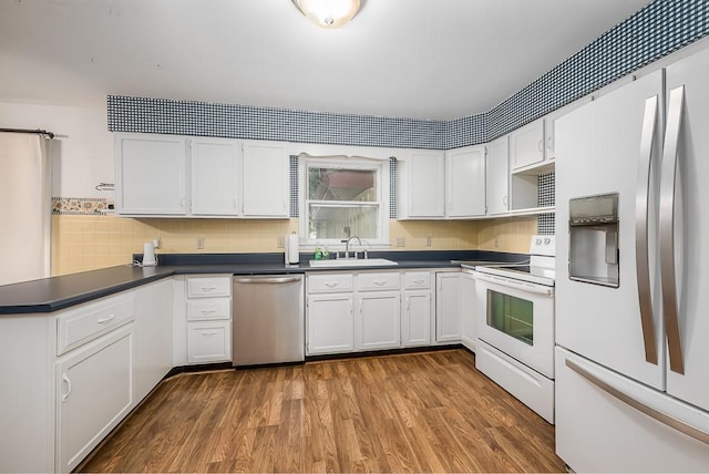 20723 Kissinger Rd, Tonganoxie, KS 66086 - kitchen featuring refrigerator with ice dispenser, dishwasher, electric range, dark countertops, and dark wood-style flooring