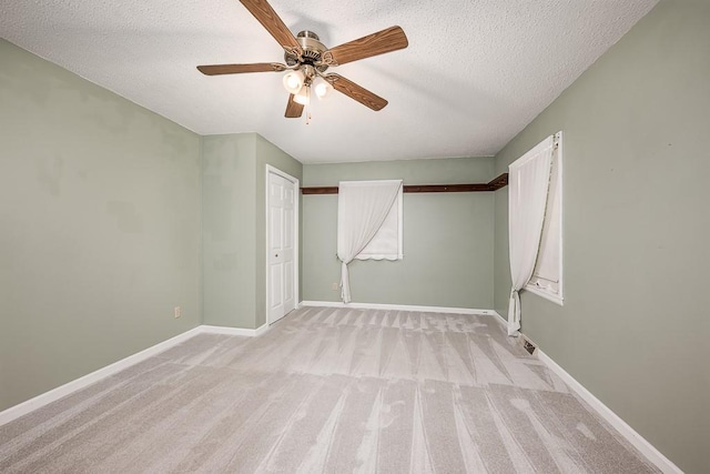 20723 Kissinger Rd, Tonganoxie, KS 66086 - unfurnished bedroom featuring light colored carpet, a textured ceiling, a ceiling fan, and a closet