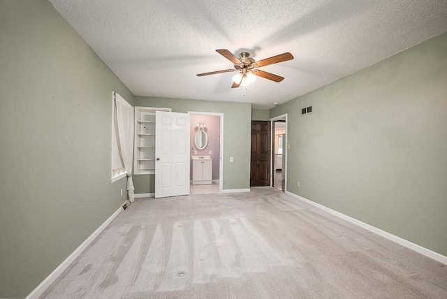 20723 Kissinger Rd, Tonganoxie, KS 66086 - unfurnished bedroom featuring a textured ceiling, light colored carpet, ensuite bathroom, and ceiling fan