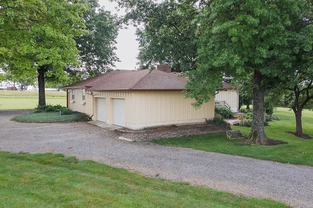 20723 Kissinger Rd, Tonganoxie, KS 66086 - view of property exterior with a chimney, a lawn, a garage, and a shingled roof